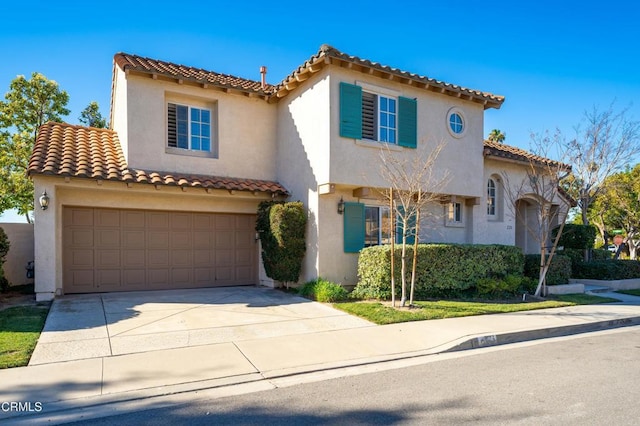 mediterranean / spanish house with a garage