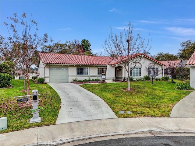 ranch-style home featuring a garage and a front lawn