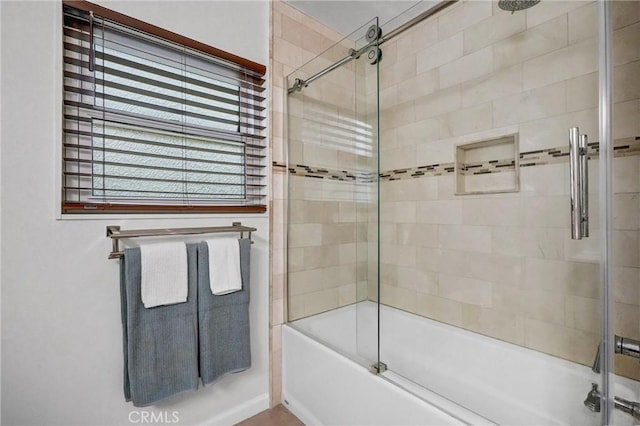 bathroom with shower / bath combination with glass door