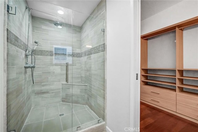 bathroom featuring a shower with shower door