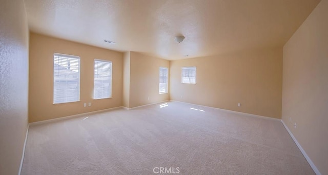 empty room featuring light carpet