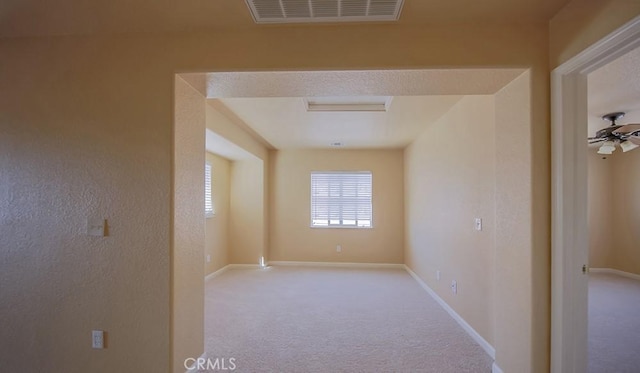 carpeted empty room featuring ceiling fan