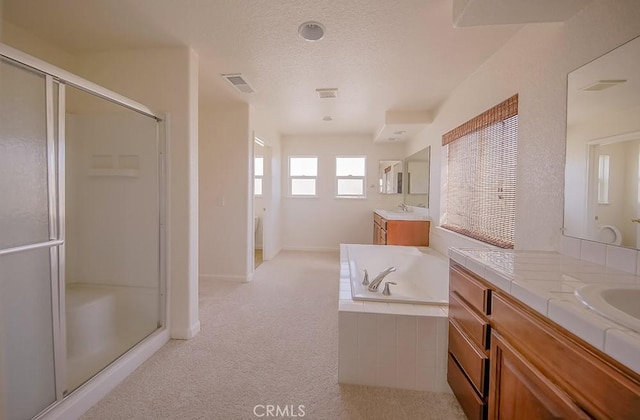 bathroom featuring vanity and shower with separate bathtub