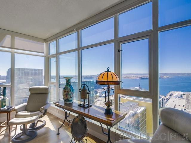 sunroom with plenty of natural light and a water view