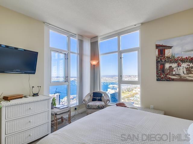 bedroom featuring a wall of windows and multiple windows