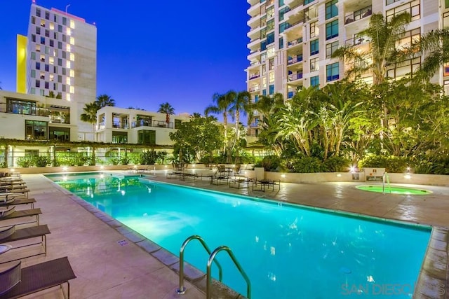 view of swimming pool with a patio area and a community hot tub