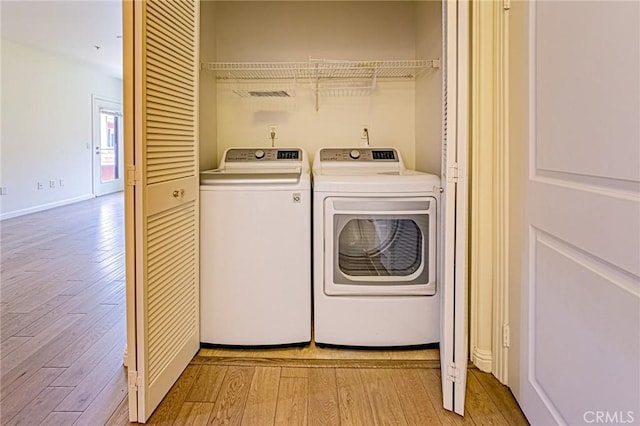 100 S Alameda St Unit 307, Los Angeles, CA 90012 - laundry area with light wood finished floors, washer and dryer, and baseboards