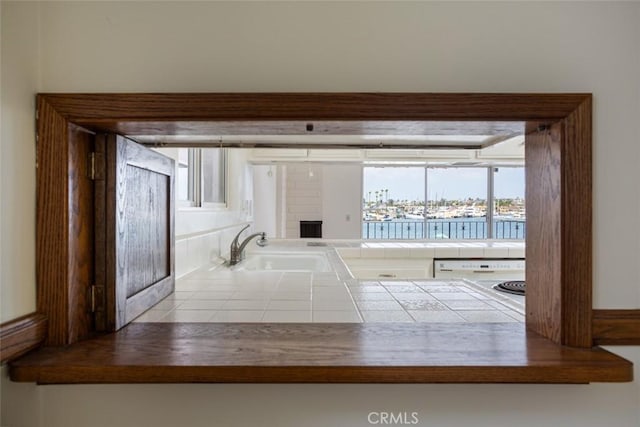 doorway to outside featuring a water view and sink