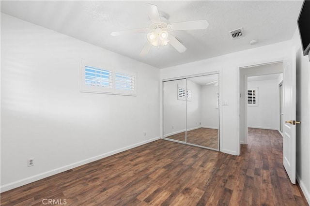 40836 36th St W, Palmdale, CA 93551 - unfurnished bedroom featuring dark wood-type flooring, baseboards, a closet, and ceiling fan