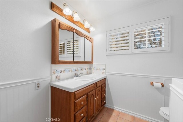 40836 36th St W, Palmdale, CA 93551 - bathroom with wainscoting, vanity, toilet, and tile patterned floors