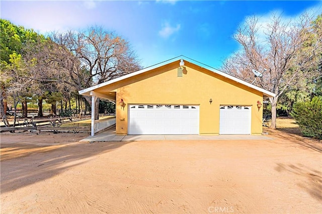 view of side of home featuring an outbuilding and a garage