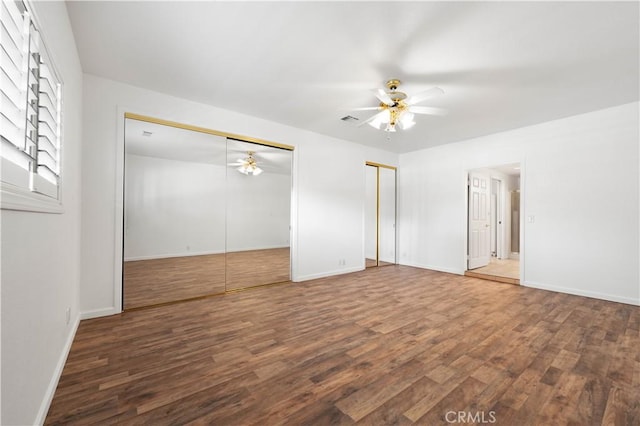 40836 36th St W, Palmdale, CA 93551 - unfurnished bedroom with two closets, wood finished floors, baseboards, and a ceiling fan