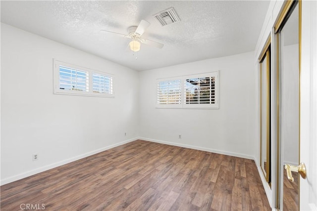 unfurnished bedroom with ceiling fan, hardwood / wood-style floors, and a textured ceiling