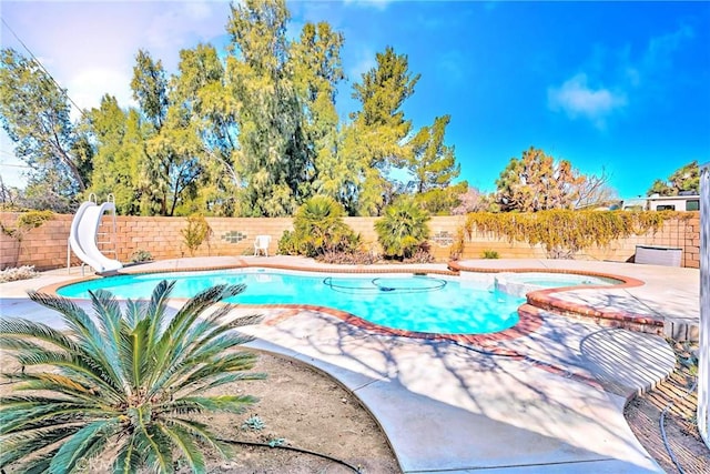 view of pool featuring an in ground hot tub and a water slide