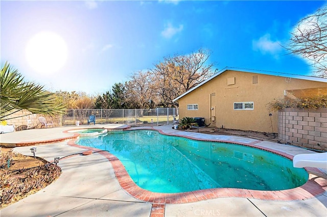 view of swimming pool featuring a patio area, a water slide, and an in ground hot tub