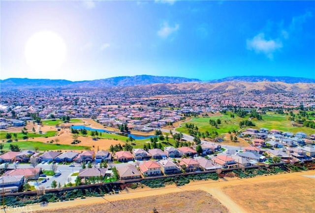 birds eye view of property with a water and mountain view