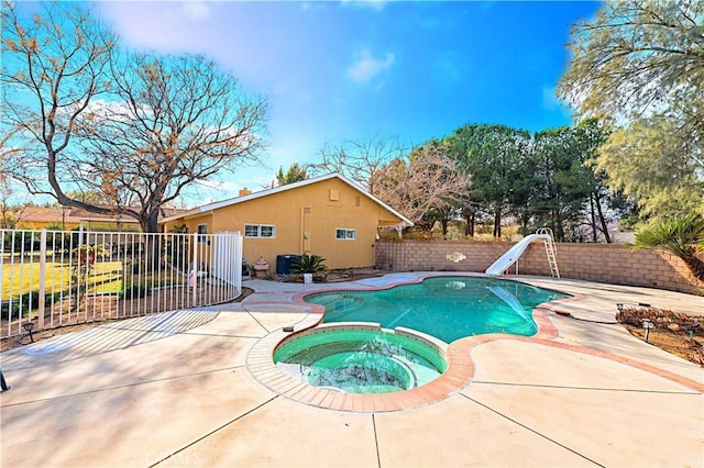 view of swimming pool featuring a patio, an in ground hot tub, and a water slide