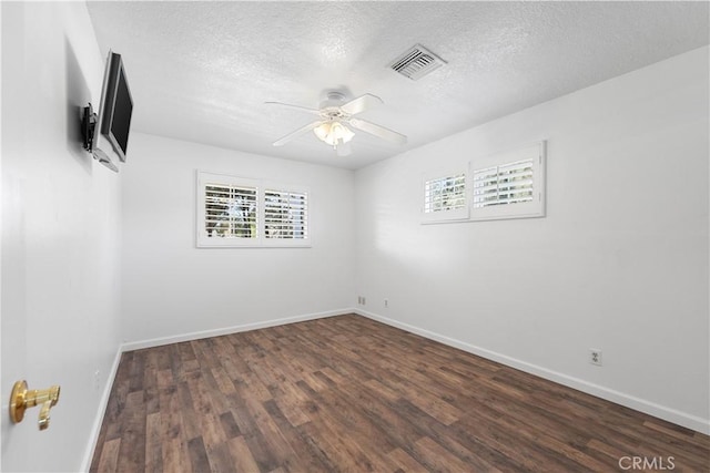 unfurnished room featuring a textured ceiling, ceiling fan, and dark hardwood / wood-style floors