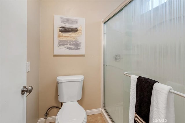 bathroom with toilet, tile patterned floors, and walk in shower