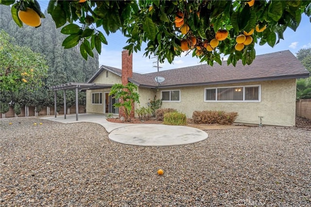 rear view of house with a pergola and a patio