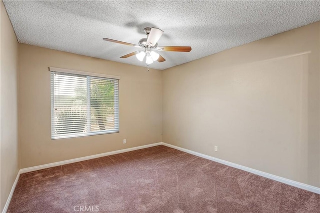 carpeted empty room with ceiling fan and a textured ceiling