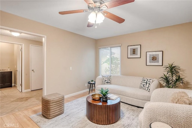 living room featuring light wood-type flooring and ceiling fan