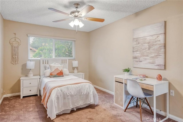 bedroom featuring ceiling fan, a textured ceiling, and carpet floors