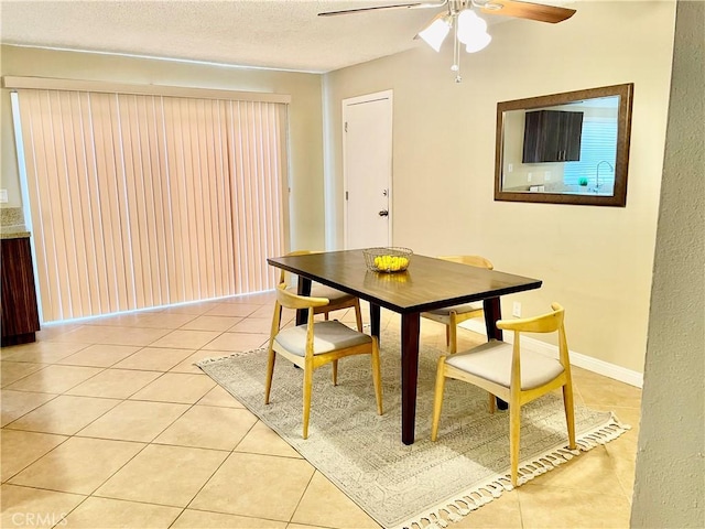 tiled dining area with ceiling fan