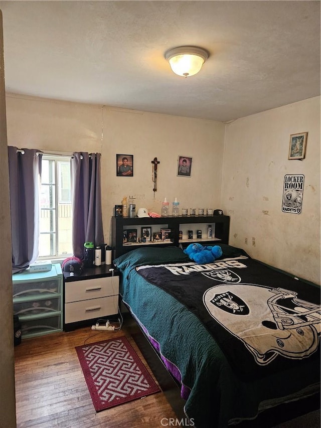 bedroom featuring wood-type flooring