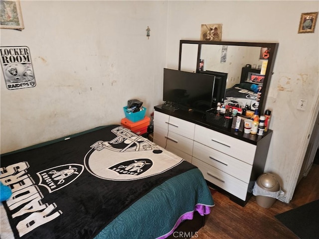 bedroom with dark hardwood / wood-style flooring