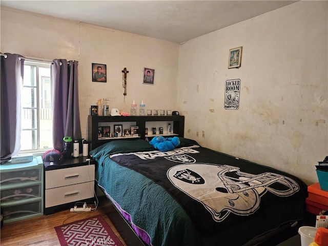 bedroom with hardwood / wood-style floors