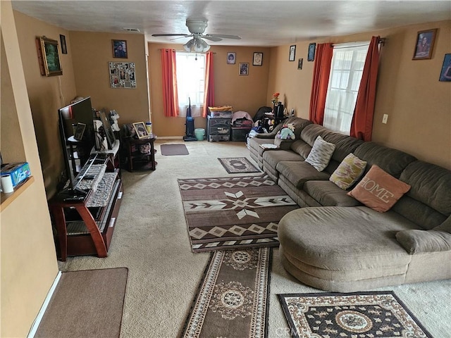 carpeted living room featuring ceiling fan