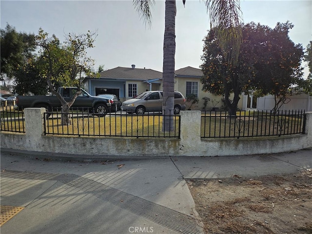 view of front of home featuring a garage and a front lawn