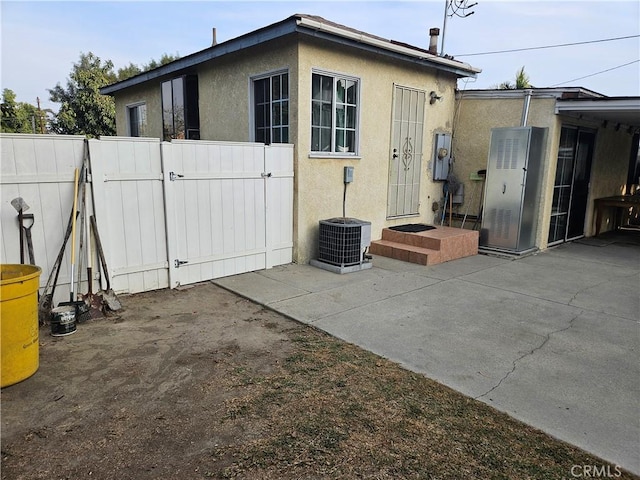 exterior space with a patio area and central air condition unit