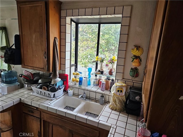 kitchen featuring tile countertops and sink