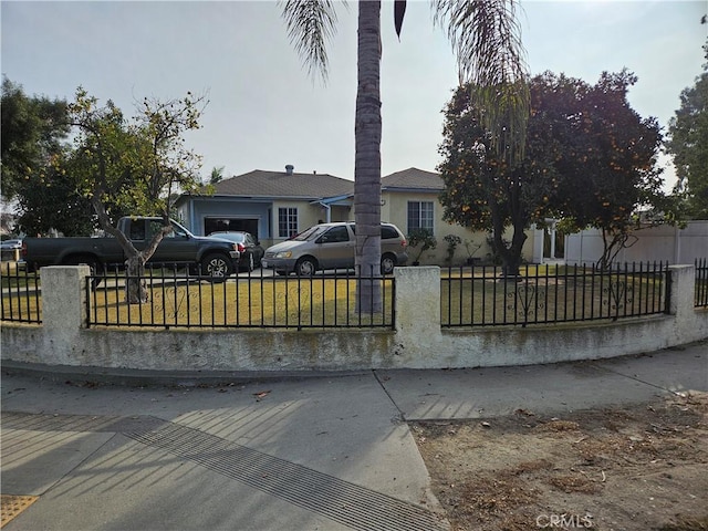 view of front of home with a garage and a front yard