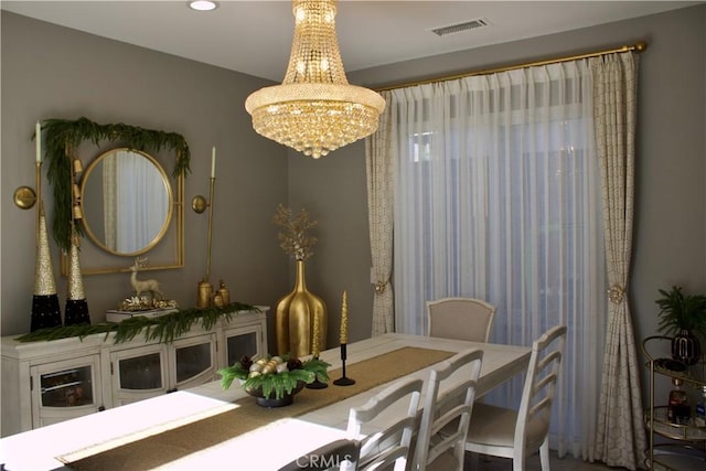 dining space with a notable chandelier