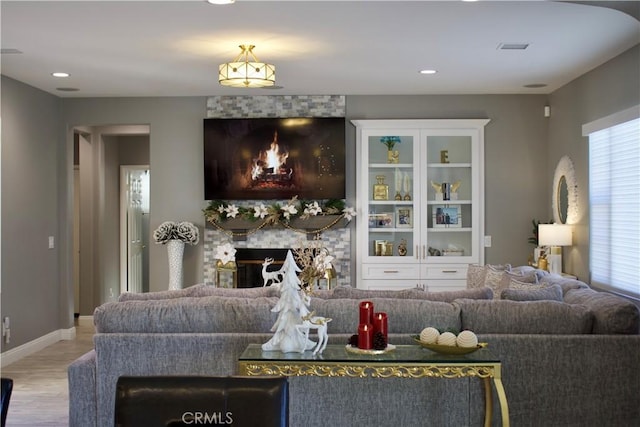 living room with a fireplace and hardwood / wood-style flooring