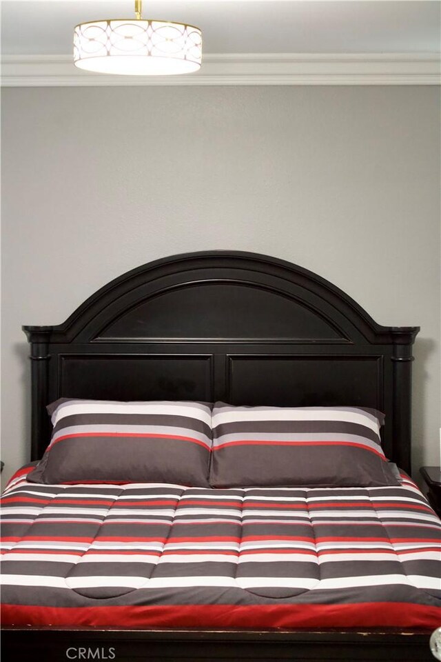 bedroom featuring crown molding