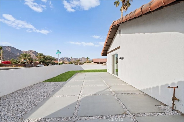 exterior space with a mountain view and a patio