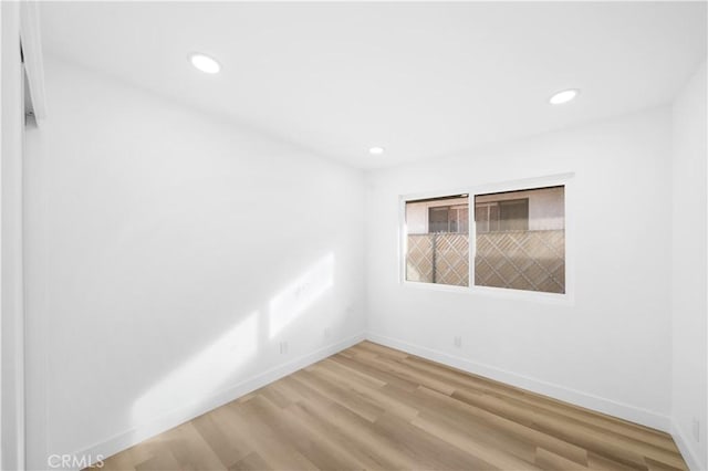 spare room with light wood-type flooring