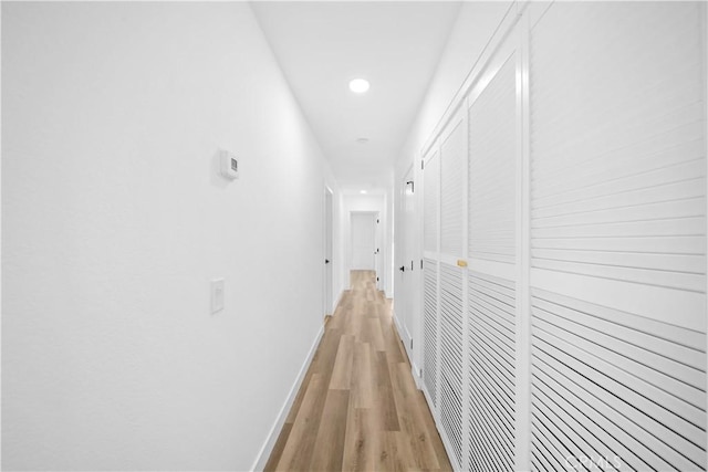 corridor with light hardwood / wood-style flooring