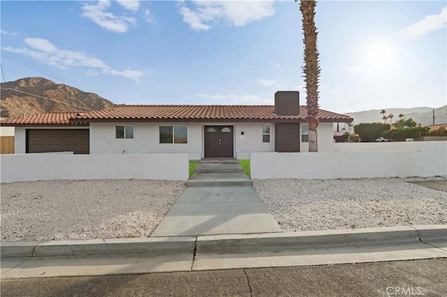 view of front of property with a mountain view and a garage