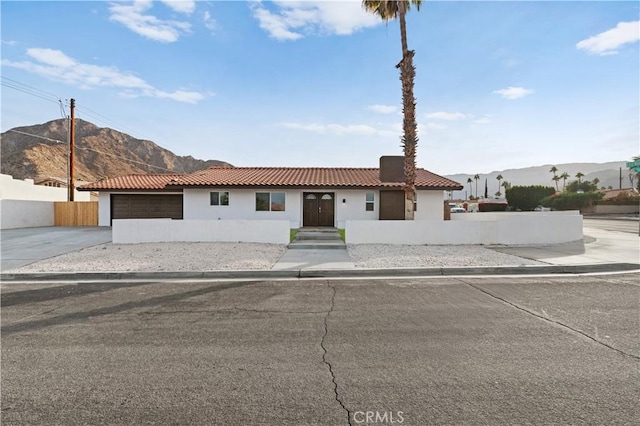 view of front facade featuring a mountain view and a garage