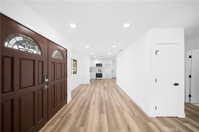 entryway with light hardwood / wood-style flooring