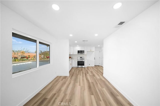 unfurnished living room with light wood-type flooring