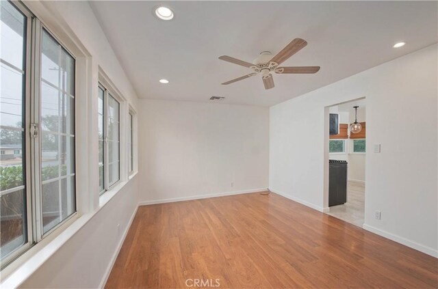 unfurnished room featuring ceiling fan and light hardwood / wood-style flooring