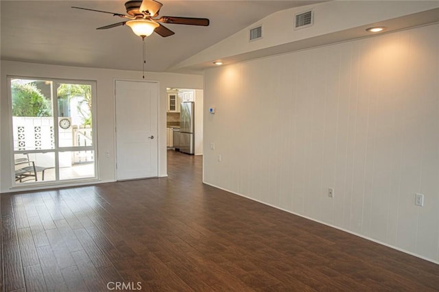 spare room with dark wood-type flooring, ceiling fan, and vaulted ceiling