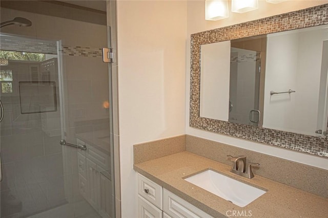 bathroom with an enclosed shower and vanity