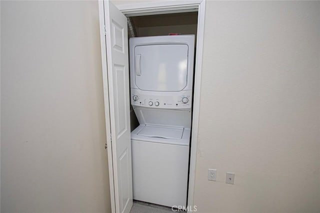 laundry room with stacked washer and clothes dryer